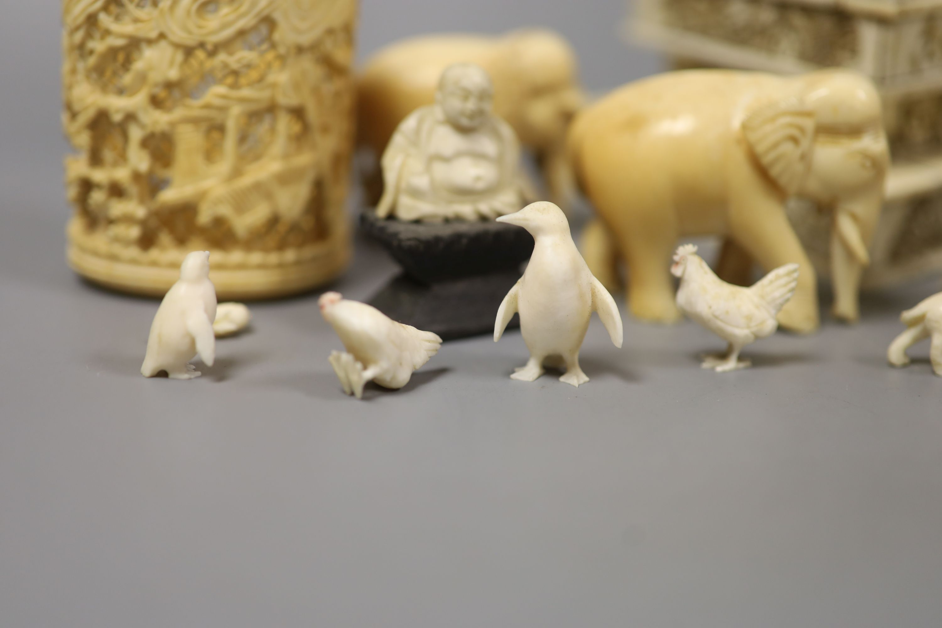 A Japanese Ivory model of a bijin, a similar model of a temple, various European Ivory models of animals and birds, an Indian Ivory figure et cetera, or late 19th or early 20th century